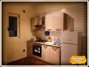 Kitchen features an oven, microwave, and sink with a faucet.