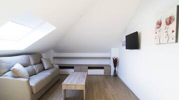 A modern living room with a sofa, a coffee table, and a built-in bench with storage.