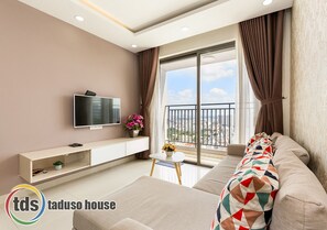 Relax in this stylish living room with a flat-screen TV, console table, and city view.