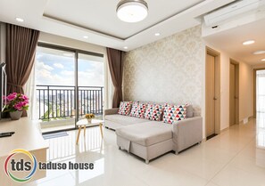 Relax in this stylish living room with a large sofa, city view, and natural decor.