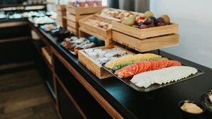 A buffet with various food items including fruits, pastries, and seafood. - Focus Hotel Premium Kraków (Kraków)