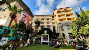 A hotel courtyard with a central fountain, surrounded by potted plants and seating areas. - Kathmandu Guest House by KGH Group (Kathmandu)