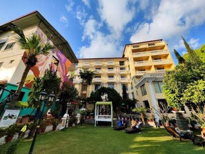 A hotel courtyard with a central fountain, surrounded by potted plants and seating areas. - Kathmandu Guest House by KGH Group (Kathmandu)