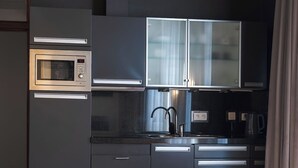 A modern kitchen with a built-in microwave, stainless steel appliances, and a sink. - Amosa Liège City Centre Apart Regence 10 (Liege)