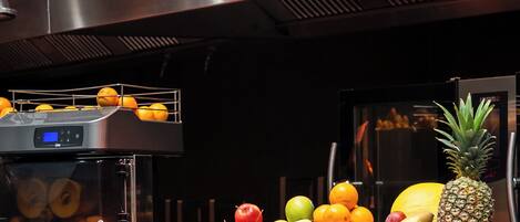 A fruit display with wooden crates labeled 'APPLE JUICE,' 'ORANGE FRESH,' and 'MULTI VITAMIN.'