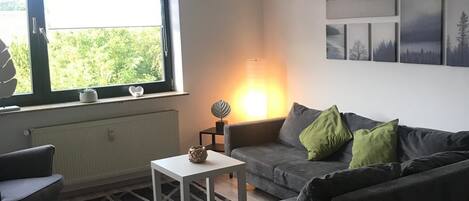 Departamento Confort | Sala de estar | Televisión de pantalla plana