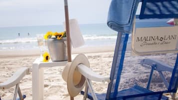 On the beach, white sand, beach umbrellas, beach towels