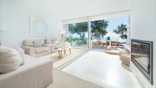 A spacious living room with a large sliding glass door leading to an outdoor dining area. - PORT NOU CA NA CATI - Chalet with sea views in Cala Bona. Free WiFi (Son Servera)