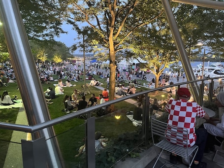 A spacious outdoor area with seating arrangements and a view of the water.