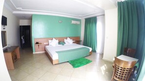Premium bedding, desk, laptop workspace, blackout drapes