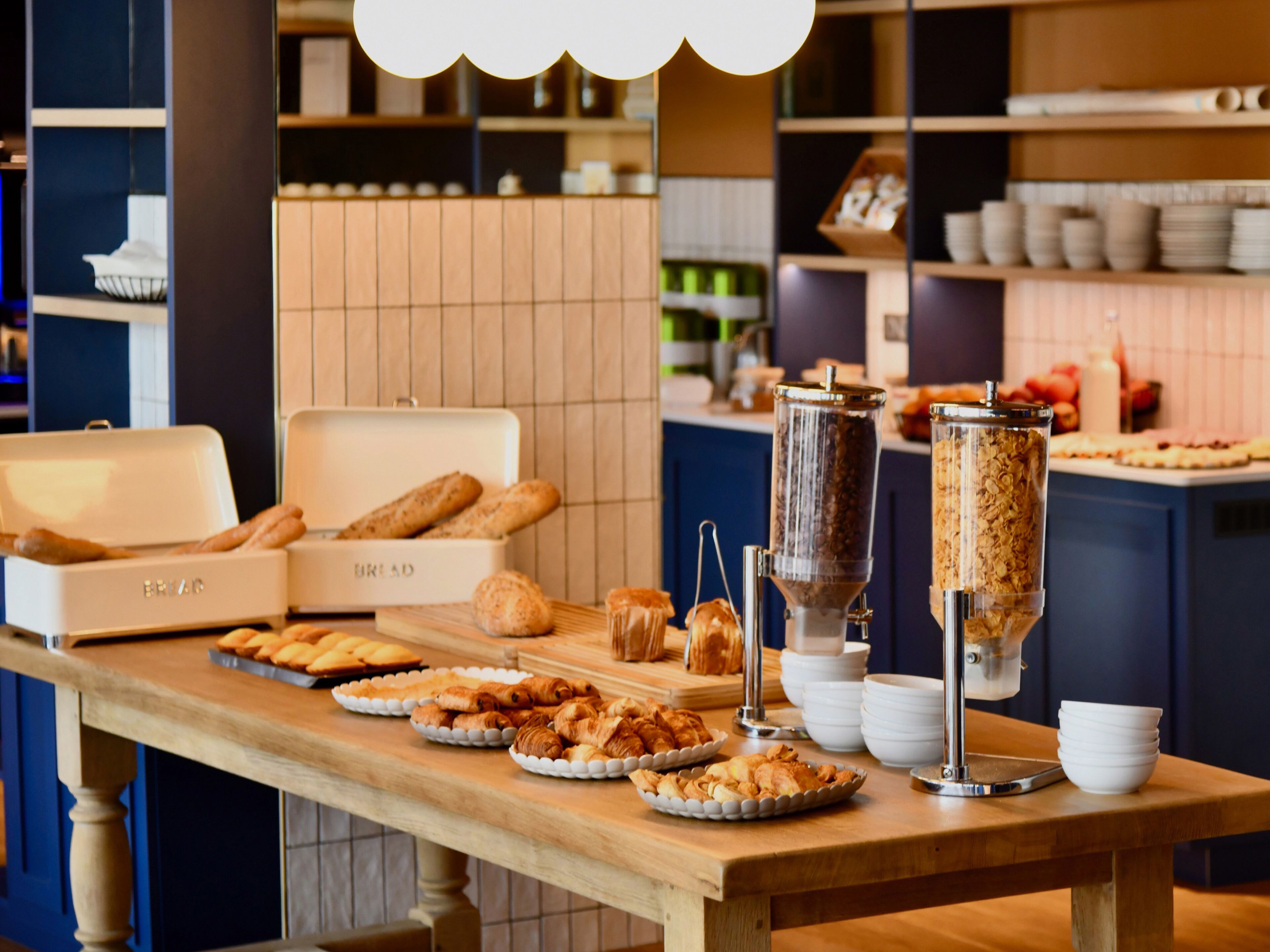 A buffet table with various baked goods and a coffee machine.
