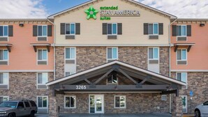 A multi-story Extended Stay America hotel with a brick facade, numbered 3265, featuring a central entrance with a covered walkway. - Extended Stay America Suites - Norco (Norco)
