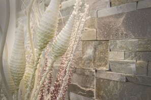 A close-up of a textured wall with stone blocks. - The Garden (Riomaggiore)