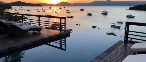 An infinity pool, pool loungers