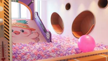 A children's play area with a ball pit, circular seating, and a slide.