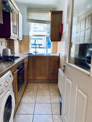 Fridge, microwave, oven, cookware/dishes/utensils