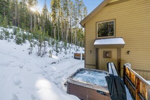 A wooden cabin with a hot tub in the snow, surrounded by trees. - High Point Lodge-Spacious Breck Ski Home, Multiple Fireplaces, Gondola 2.1mi, Sleeps 10 (Breckenridge)