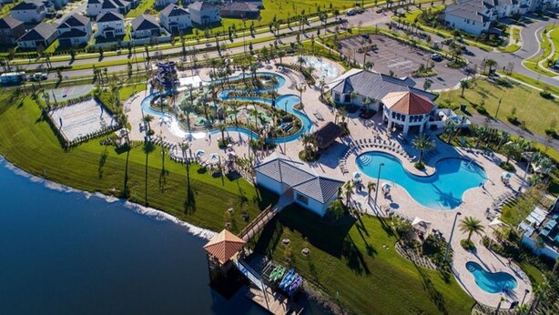 An aerial view of a resort with a large swimming pool, a dock, and a marina. - Fresh Heaven Pool Home by AV Dreams (Kissimmee)