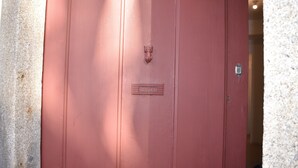 A red door with a metal handle and a keyhole.