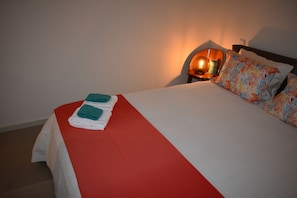 Cozy retreat with a neatly made bed and soft lighting.