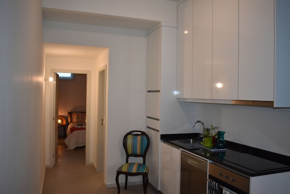 Enjoy a compact kitchen with dishwasher and sink, perfect for preparing meals.