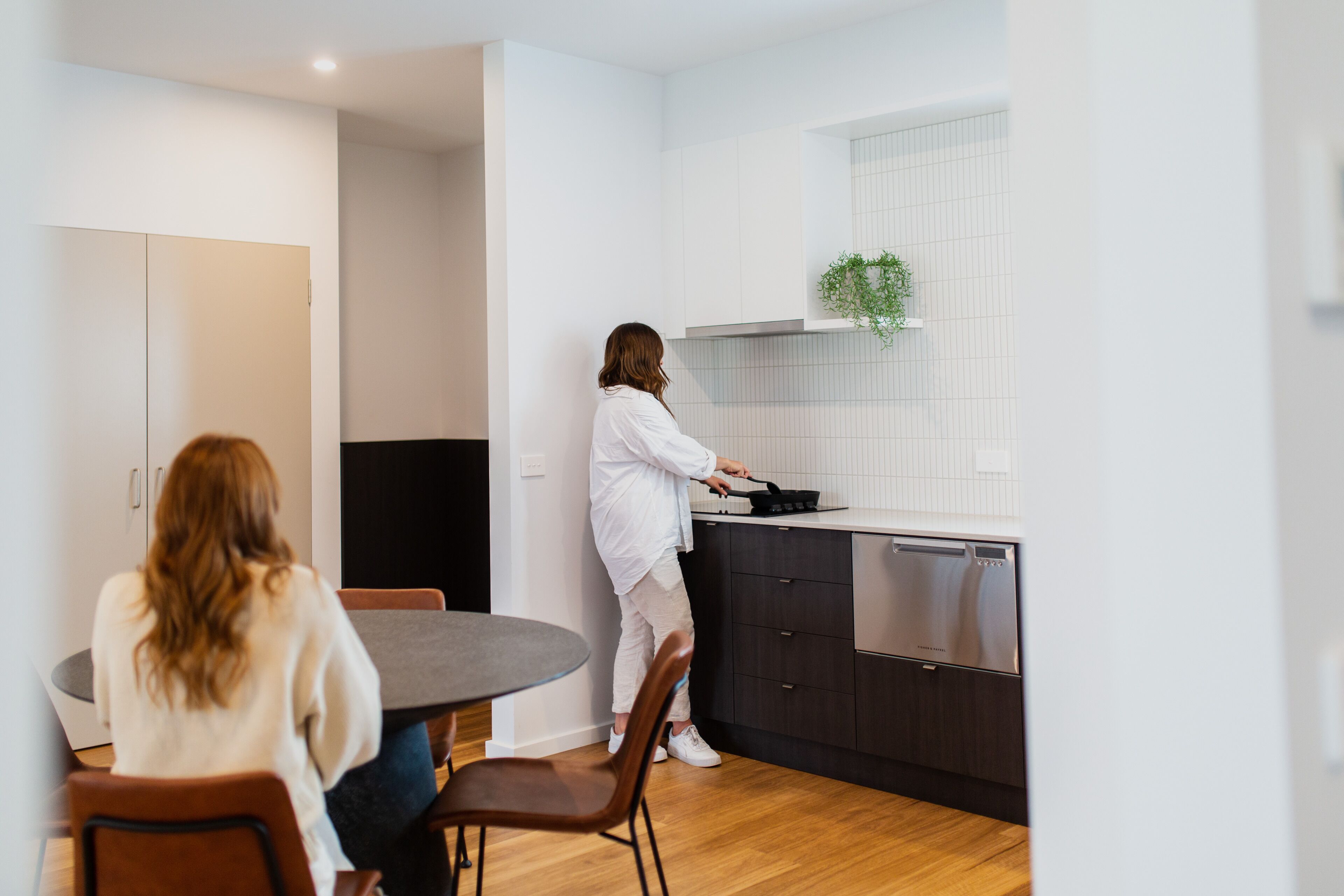 A modern kitchen with a dining area.