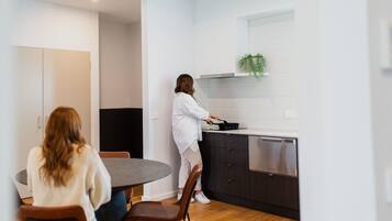 A modern kitchen with a dining area.