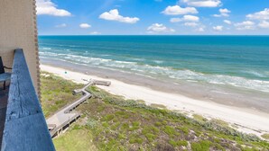 A beach view with a wooden walkway leading to the shore, a clear sky, and the ocean. - Sea Gull #1110: Beachfront 3 Bedroom 2.5 Bathroom With Spectacular Views and 24 Hour Management (Port Aransas)