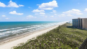 Blick auf einen Strand mit einem Gebäude direkt am Ufer.