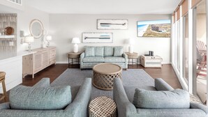 A modern living room with a sofa set, a coffee table, and a view of the beach through large windows. - Sea Gull #609: Beachfront 2 Bedroom 2 Bathroom With Spectacular Views and 24 Hour Management (Port Aransas)