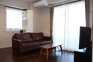 Apartment, 2 Bedrooms, Non Smoking with Balcony | Living area | Flat-screen TV, books, video library