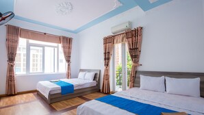 A hotel room with two beds, a large window, and an air conditioning unit. - DREAM HOUSE VILLA Vung Tau (Tp. Vũng Tàu)