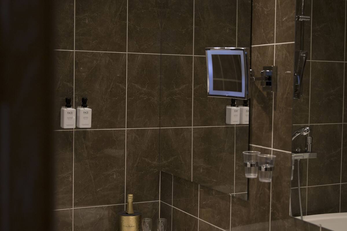 deluxe room | bathroom | separate bathtub and shower, hair dryer, towels, soap