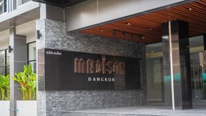 A modern building facade with a large sign reading "MAISON BANGKOK" and a staircase leading to the entrance. - Madison Bangkok (Bangkok)