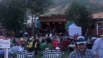 An outdoor event with a stage and audience.
