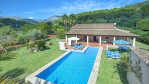 A swimming pool with lounge chairs, a covered patio, and a view of mountains. - VILLA ROMEU - 10 MIN WALK TO THE OLD TOWN (Pollensa)