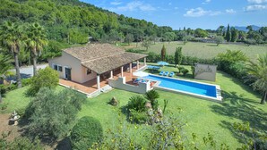 A villa with a swimming pool, surrounded by lush greenery and hills. - VILLA ROMEU - 10 MIN WALK TO THE OLD TOWN (Pollensa)