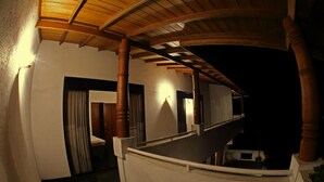 A corridor with wooden beams and columns, leading to a staircase. - Primrose Bungalow (Kandy)