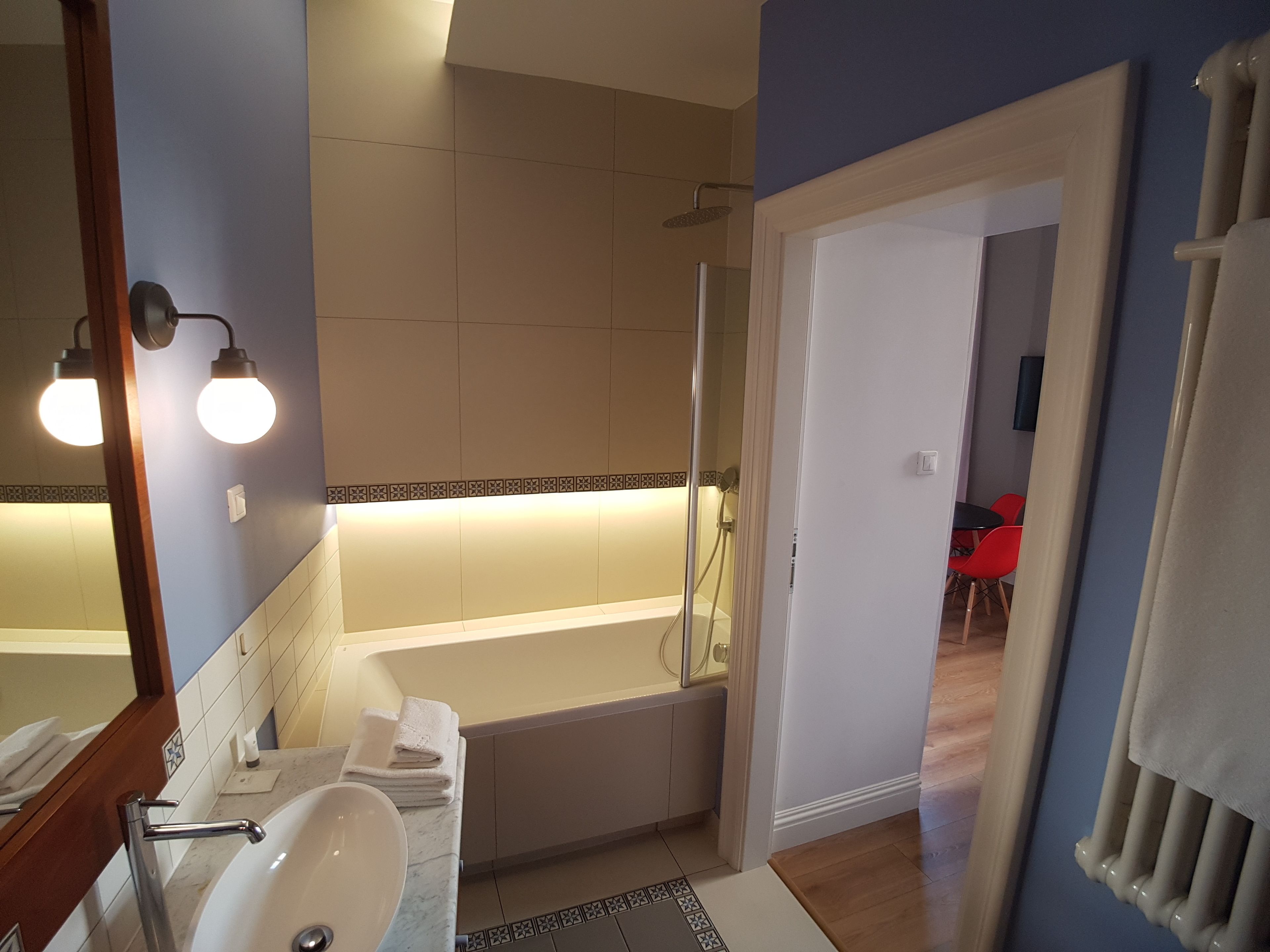 A modern bathroom with a bathtub, a sink, and a shower.