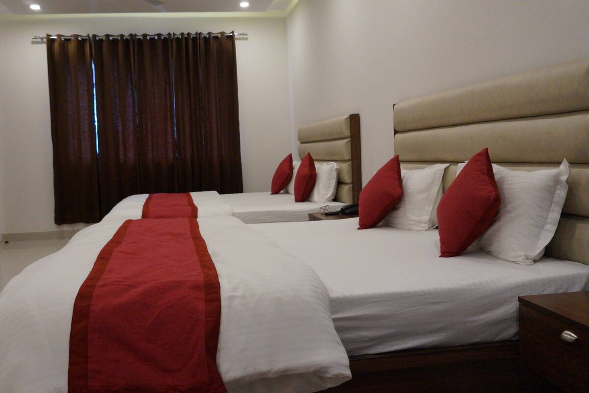 Premium bedding, desk, laptop workspace, blackout drapes