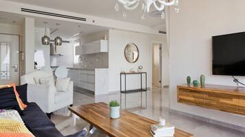 Luxury Apartment | Living area | 50-inch plasma TV with cable channels, TV