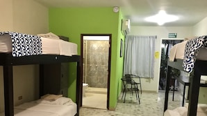 A room with bunk beds, a shower area, and a chair. - Hostal Casa Huasteca (Ciudad Valles)