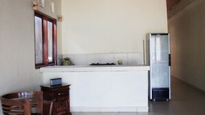 A kitchen with a refrigerator, a sink, and a wooden cabinet. - Bale Gerupuk (Kuta)