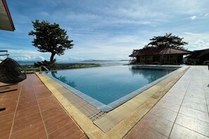 A rectangular pool with a tiled edge, surrounded by a wooden deck and a tiled walkway. - Punta de Fabian powered by Cocotel (Baras)