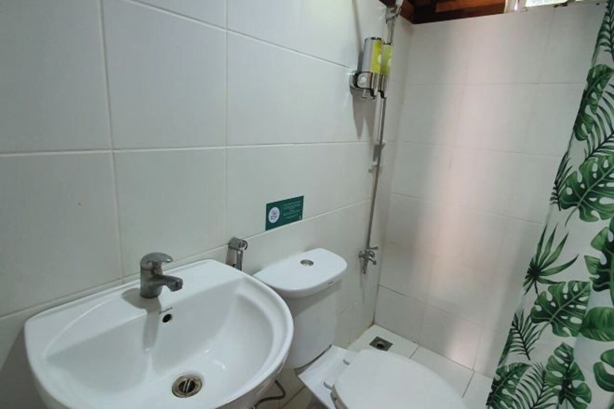 A bathroom with a sink, toilet, and shower.