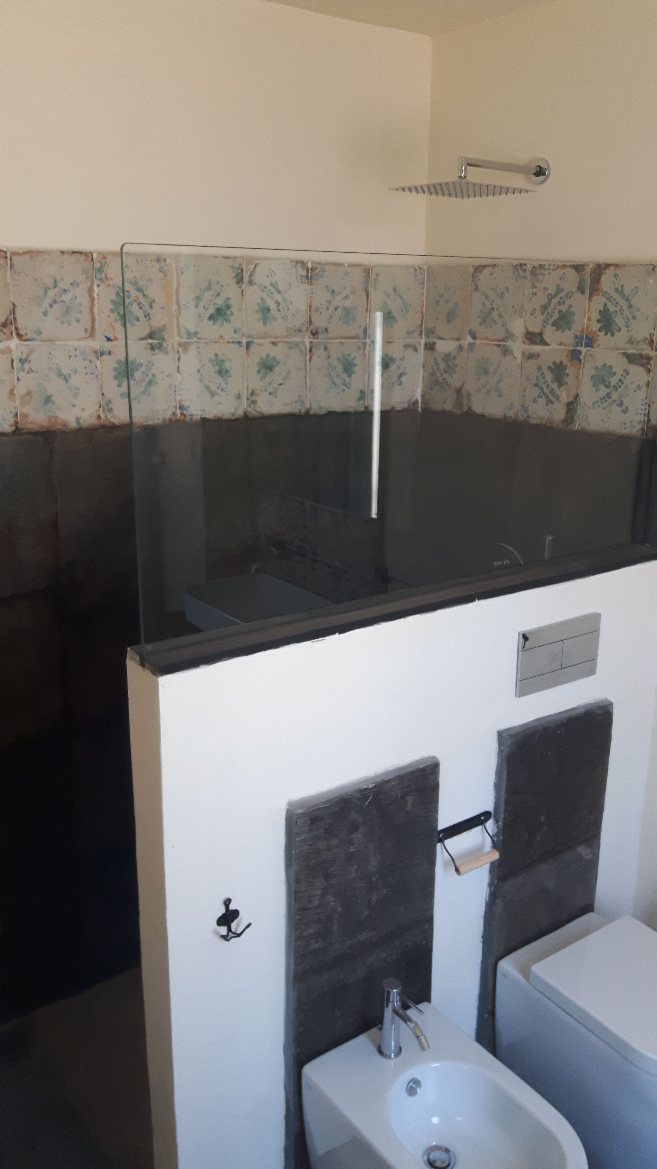 A bathroom with a shower, a sink, and a mirror.