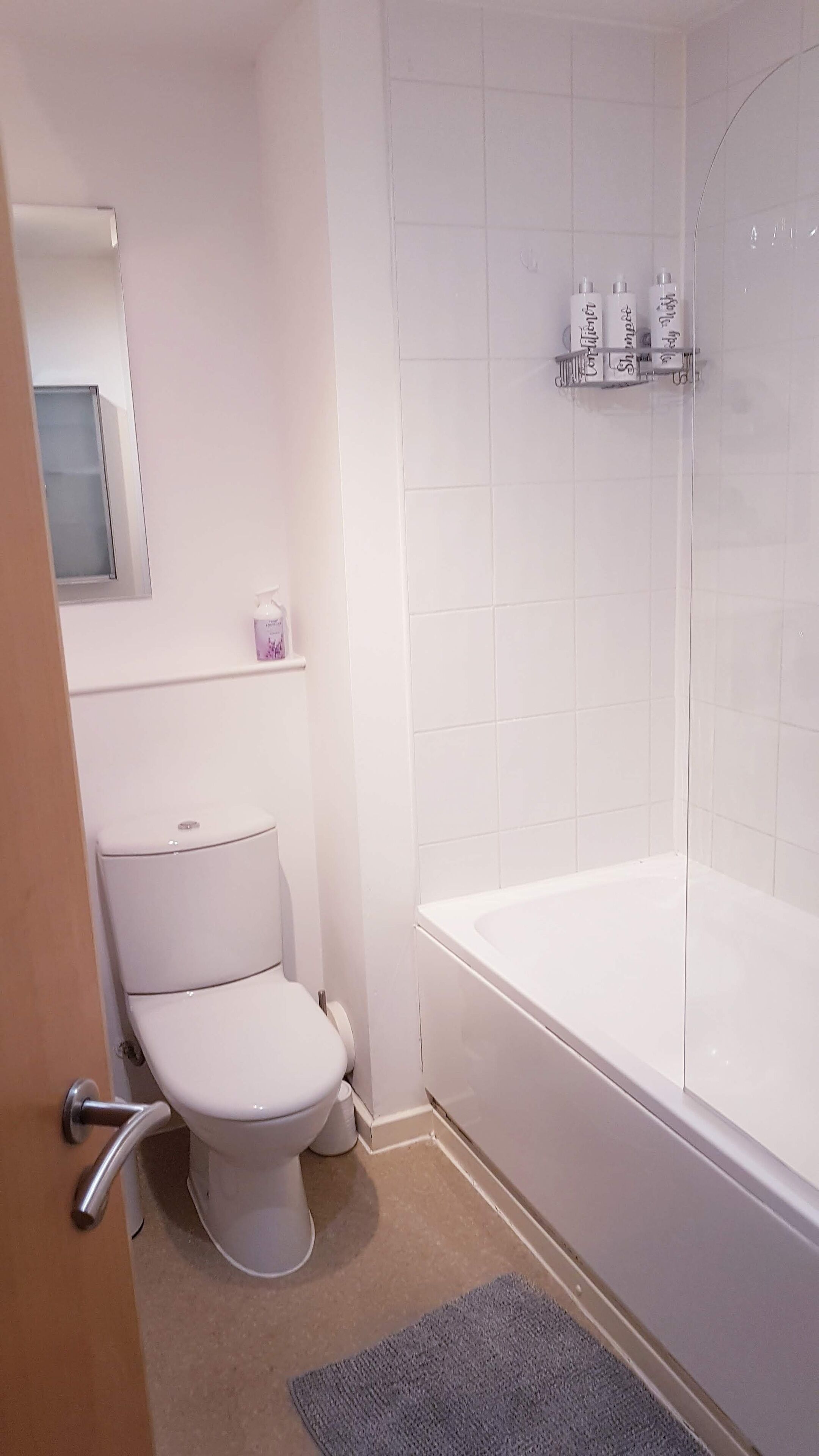 A bathroom with a toilet, a shower, and a bathtub.
