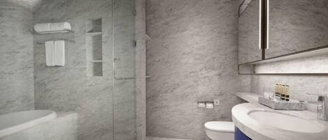 A modern bathroom with a glass-enclosed shower, a standalone bathtub, and a vanity with a sink and mirror.