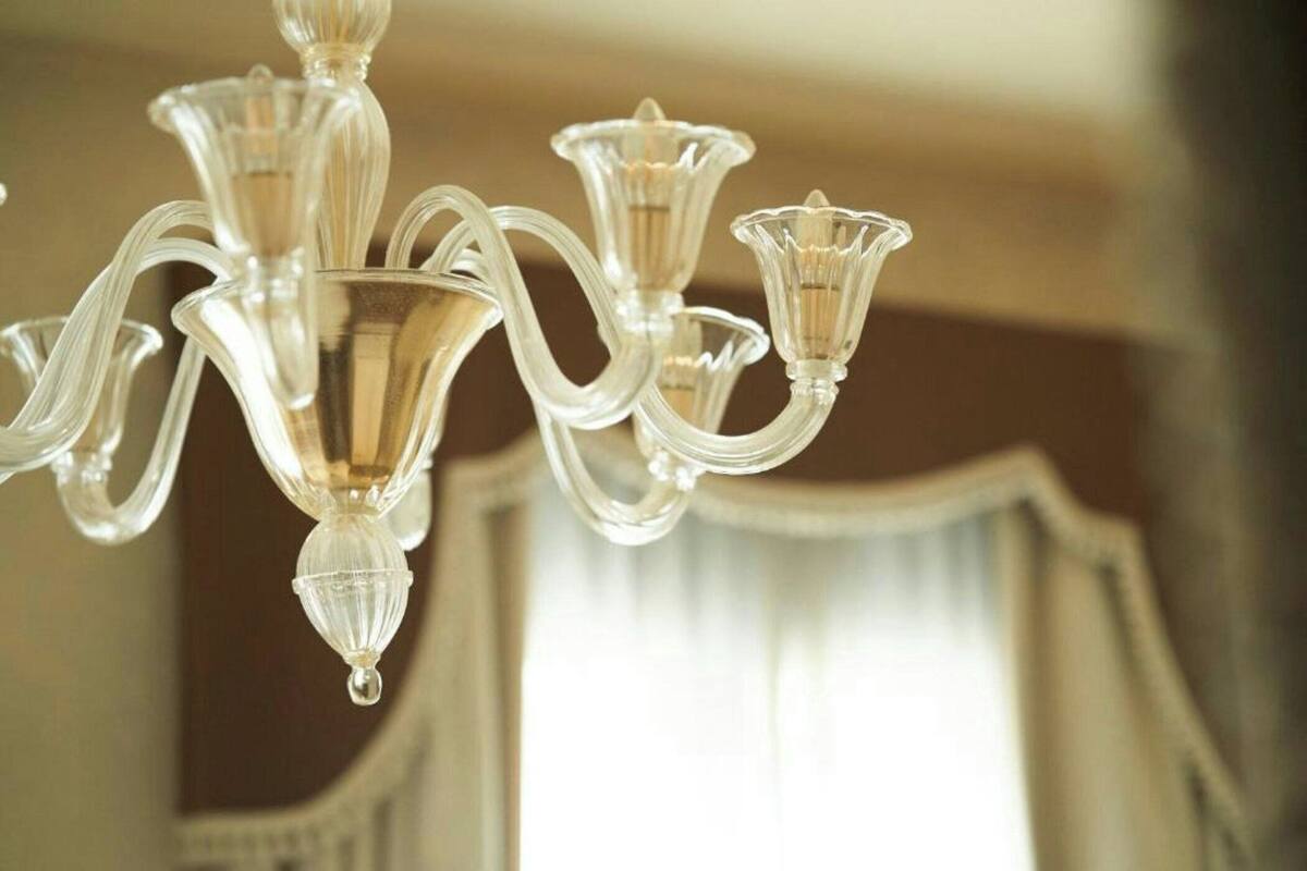 A chandelier with multiple arms and clear glass decorations.