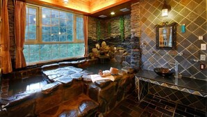 A spa area with a stone wall, a wooden ceiling, and a window with curtains. - Ming Lu Holiday Hotel (Ren'ai)